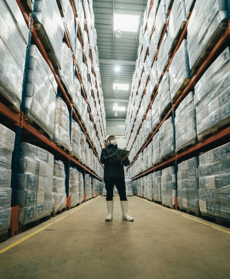 worker counting stock in a warehouse for warehouse management software article