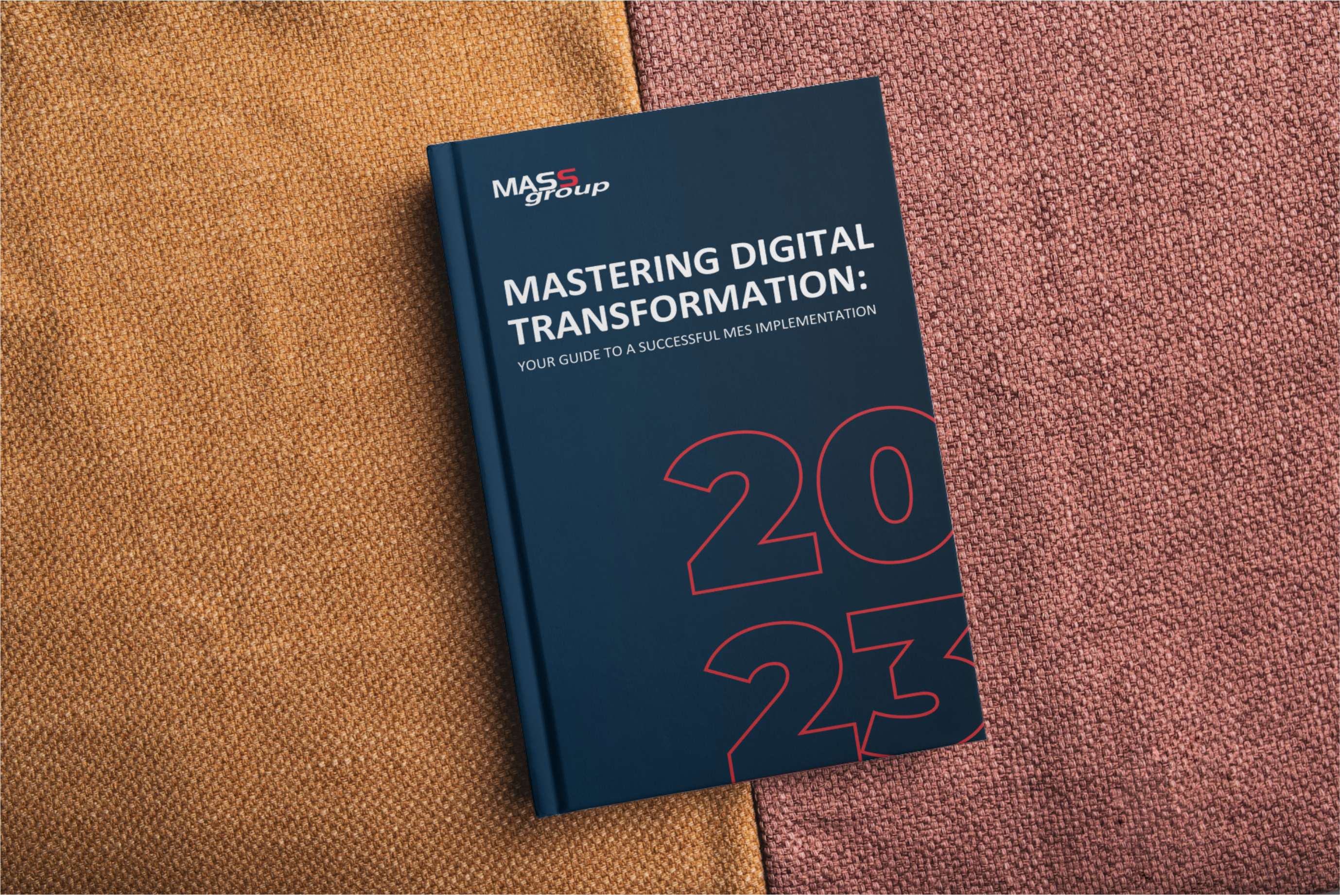 Cover of MASS Group's 2023 guidebook titled 'Mastering Digital Transformation: Your Guide to a Successful MES Implementation' placed on a textured surface